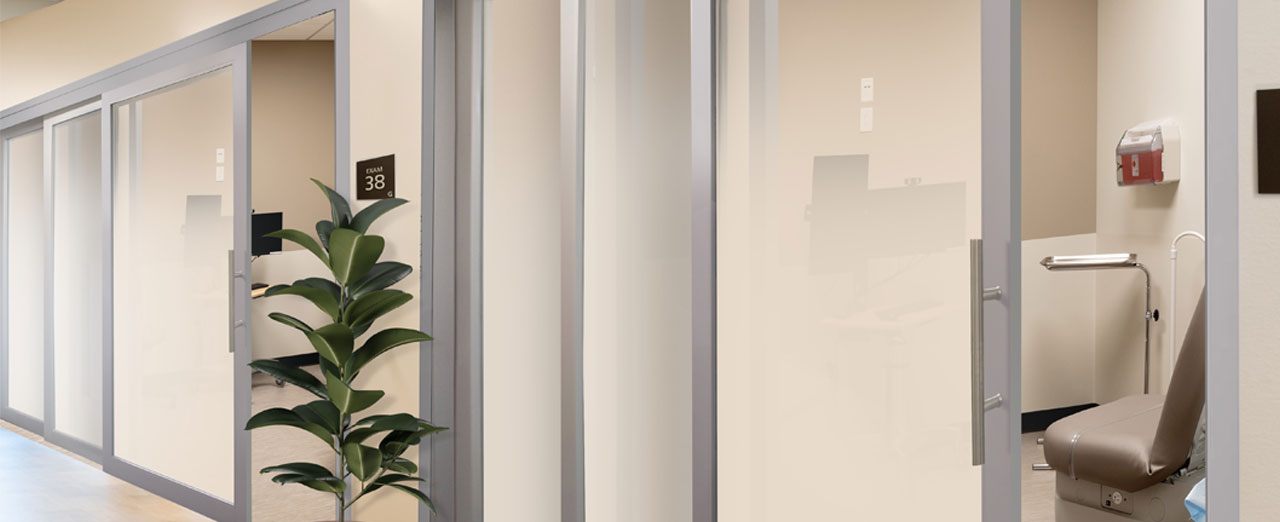 Telescoping sliding doors with soft close technology installed in a commercial medical office.
