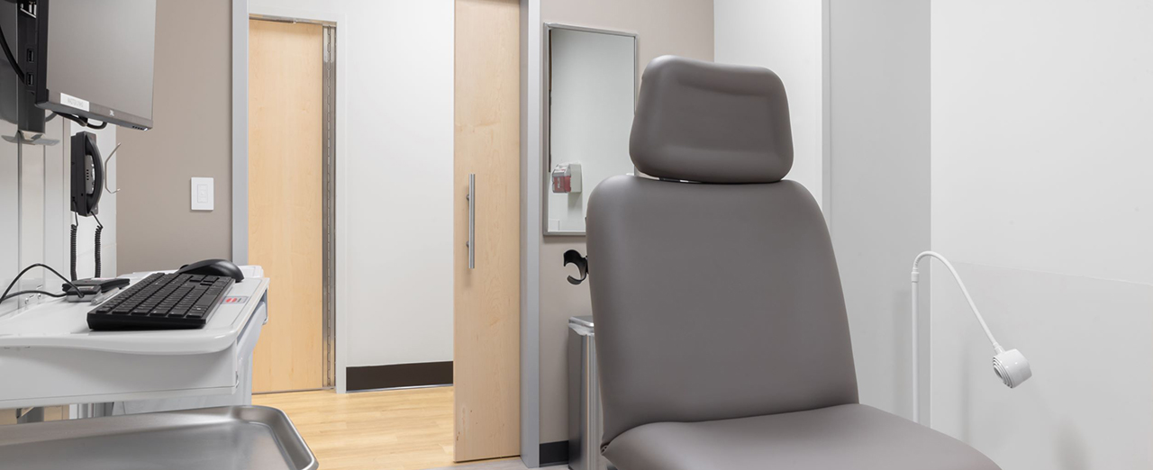 Medical exam room featuring a wooden sliding barn door by AD Systems. 