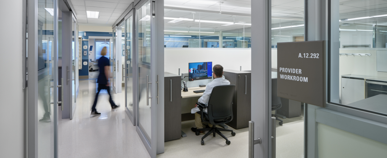 Healthcare provider workroom with sliding glass doors optimizing space and visibility.