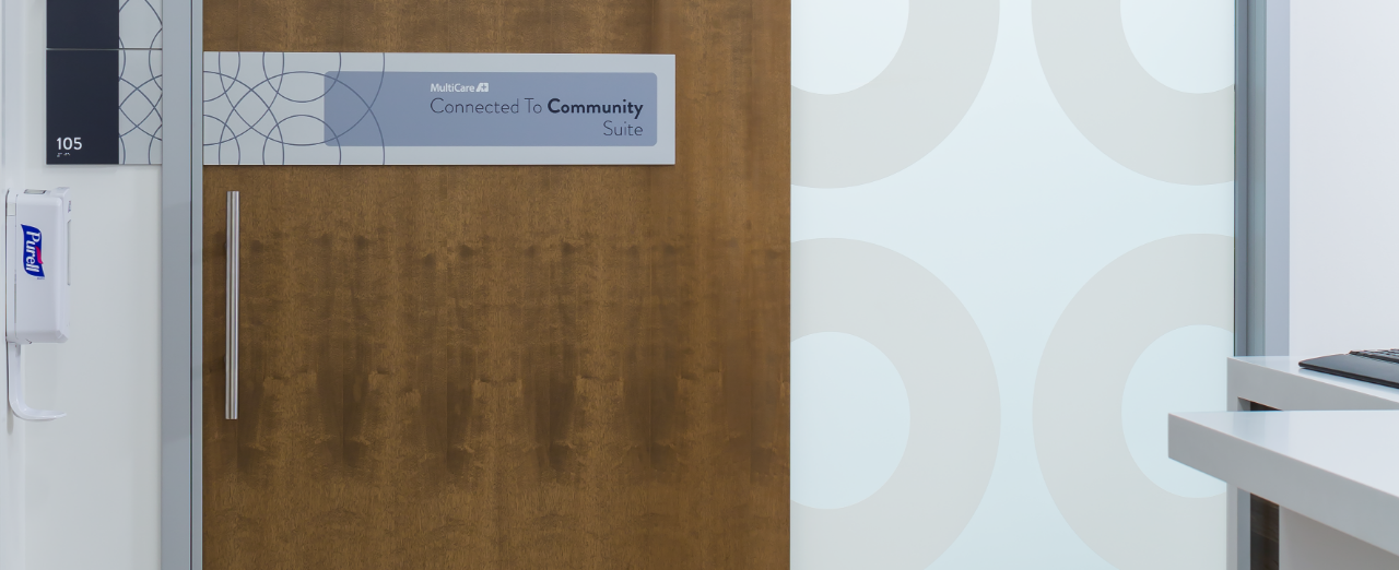 InsetSlide™ wooden sliding door features signage that assists with wayfinding.