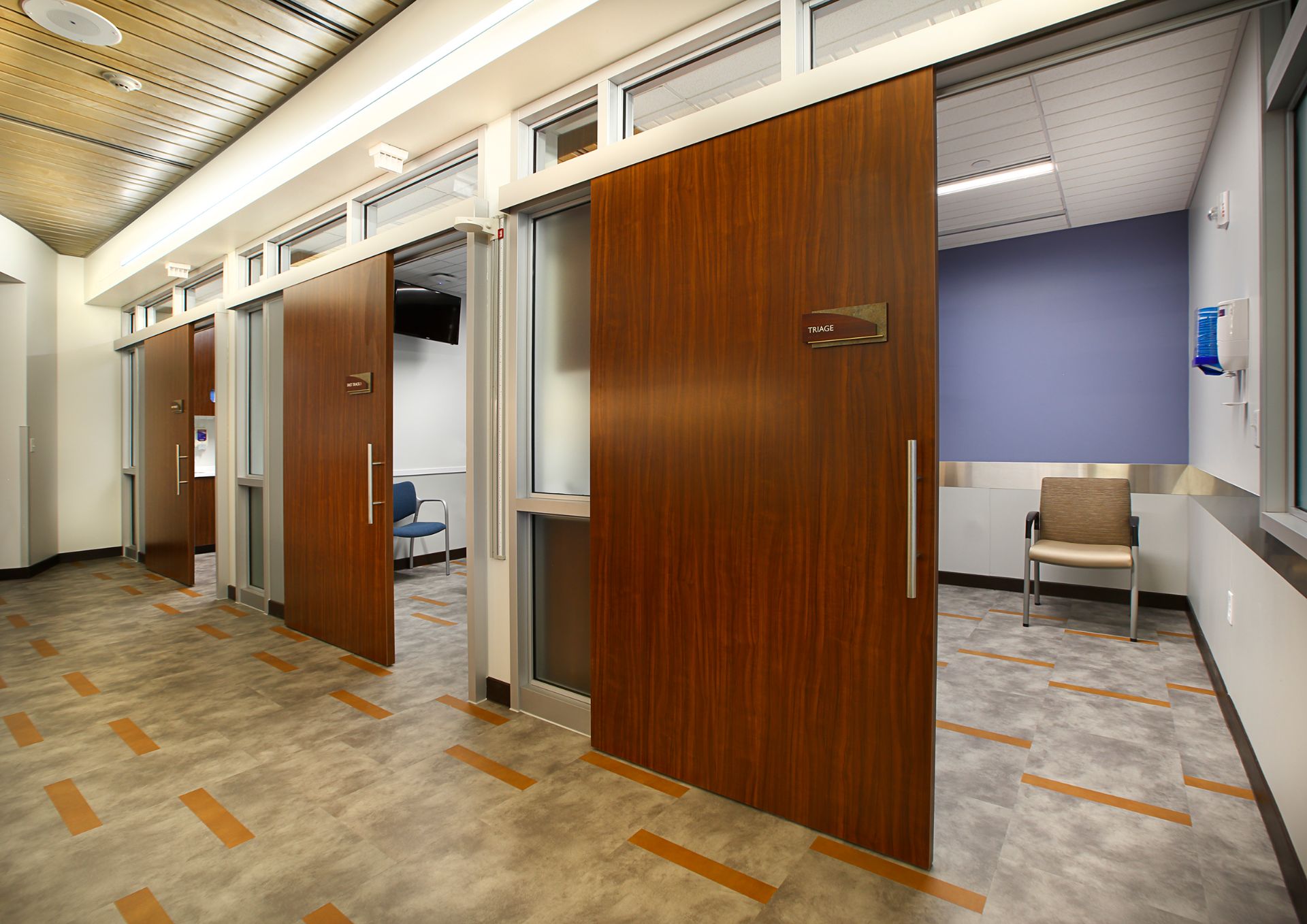 3 exam rooms with wooden medical sliding doors.